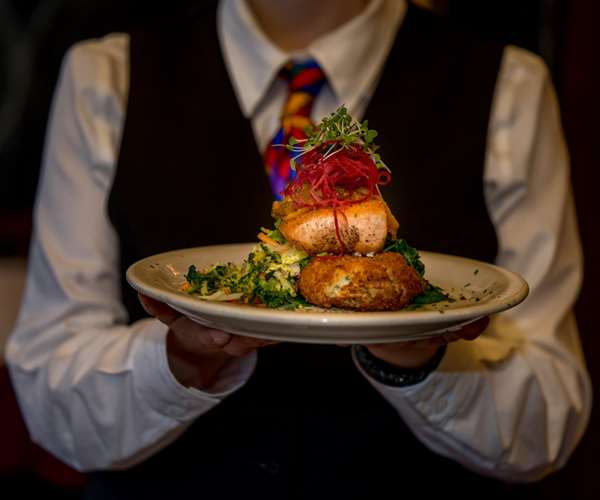 server holding a salmon dish